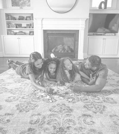Area-Rug-Cleaning-Family-Laying-on-Clean-Rug Family laying on a clean area rug in the middle of their living room.