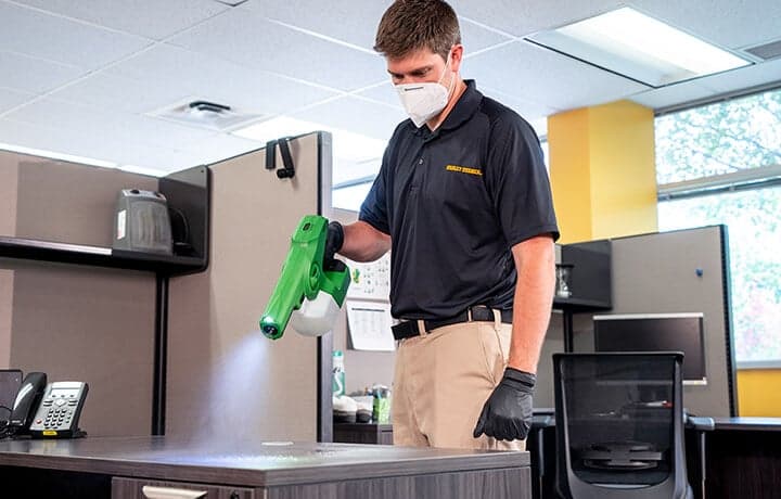 technician-disinfecting-surface Technician disinfecting with electrostatic sprayer