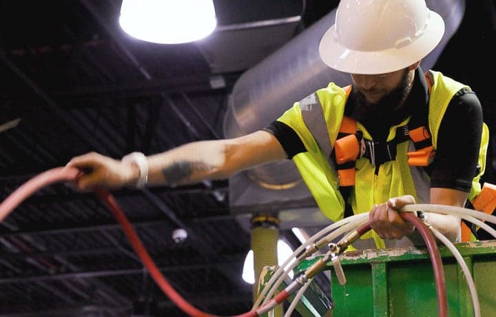 Stanley Steemer Technician Preparing Air Duct Cleaning Equipment Stanley Steemer technician preparing air duct cleaning equipment