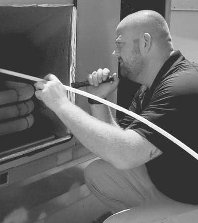 Stanley Steemer Technician Inspecting an HVAC Rooftop Unit Stanley Steemer technician inspecting an HVAC rooftop unit