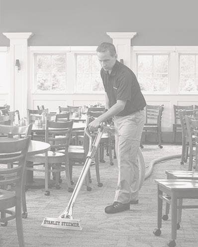 Commercial-Cleaning-Certified-Technician-Cleaning-Restaurant Stanley Steemer technician cleaning the carpet at a restaurant.