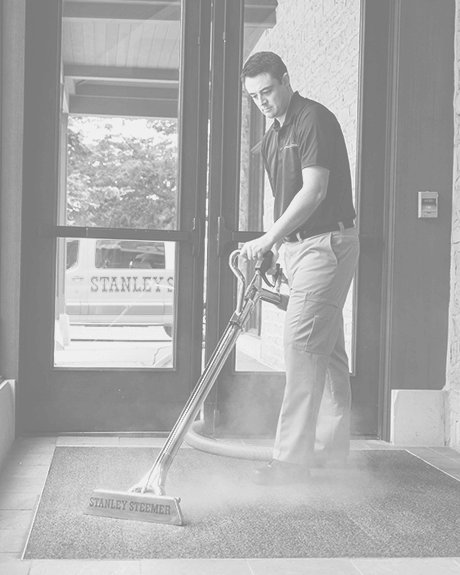 Stanley Steemer technician cleaning carpet in event space lobby Stanley Steemer technician cleaning carpet in event space lobby