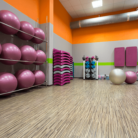 Fitness room with laminate floors and workout equipment Fitness room with laminate floors and workout equipment