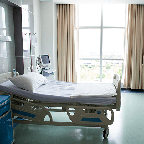 Patient room in hospital with bed and window Patient room in hospital with bed and window
