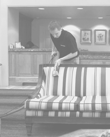 Stanley Steemer technician cleaning fabric upholstery in hotel lobby Stanley Steemer technician cleaning fabric upholstery in hotel lobby