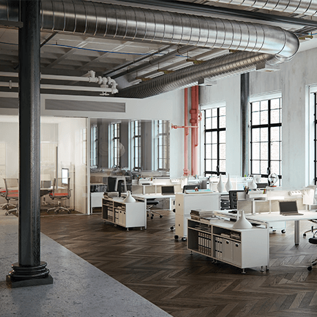 Desks inside industrial building with vents showing Desks inside industrial building with vents showing