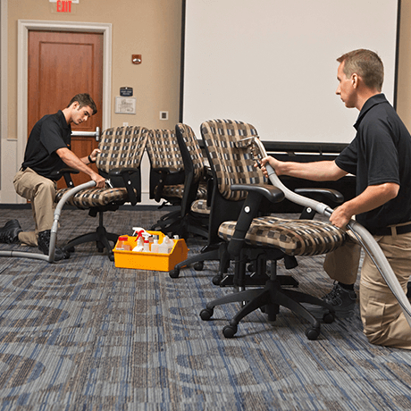 Stanley Steemer technicians cleaning upholstery on swivel chairs in office