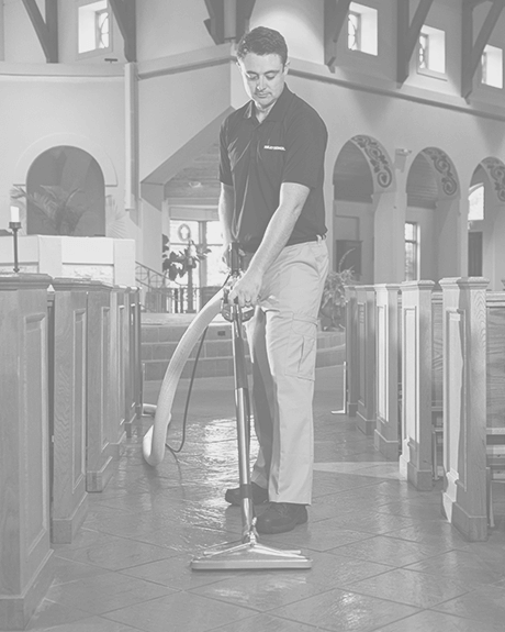 Stanley Steemer technician cleaning tile and grout in church Stanley Steemer technician cleaning tile and grout in church