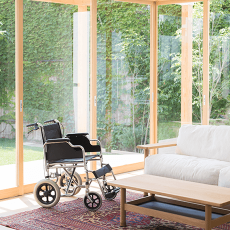 Communal room of retirement facility with area rug and wheelchair