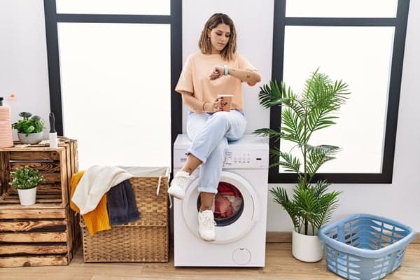 Woman on Dryer_Resized PS woman sitting on dryer checking watch