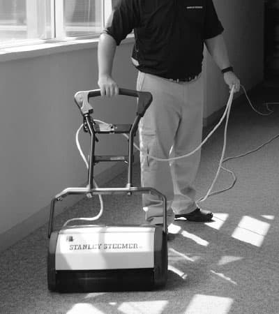 Stanley Steemer Technician Operating a Crb Machine to Perform an Encapsulation Carpet Cleaning Stanley Steemer technician operating a CRB machine to perform an encapsulation carpet cleaning