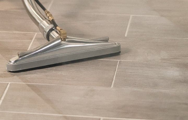 Tile floors being professionally cleaned Tile floors being professionally cleaned