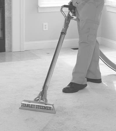 Technician professionally cleaning carpet Technician professionally cleaning carpet