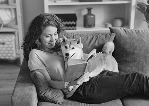 Woman and dog lounging on clean couch Woman and dog lounging on clean couch