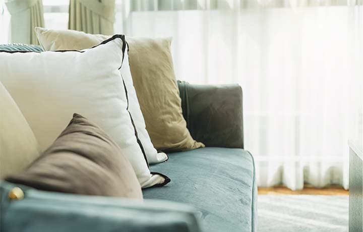 Teal microfiber couch in clean living room Teal microfiber couch in clean living room