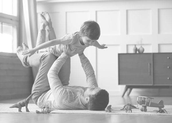 A Dad and Son Play with Each Other Lying on Top Luxury Vinyl Tile Flooring A dad and son play with each other lying on top luxury vinyl tile flooring