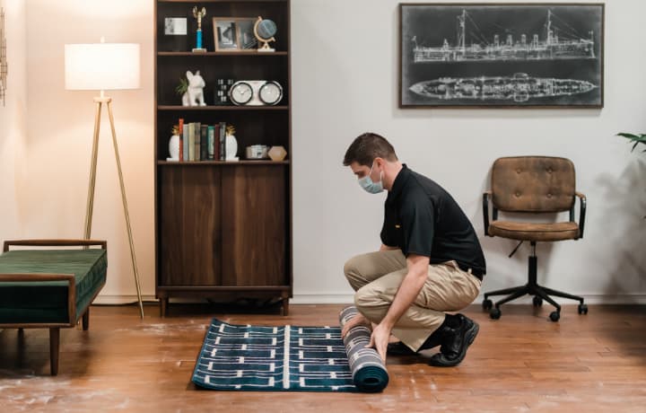 Technician getting ready to clean area rug