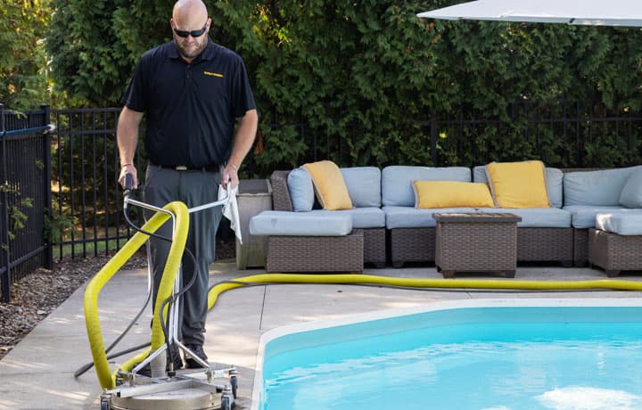 Stanley Steemer technician applying encapsulant cleaner to surround soil and dirt for easy removal