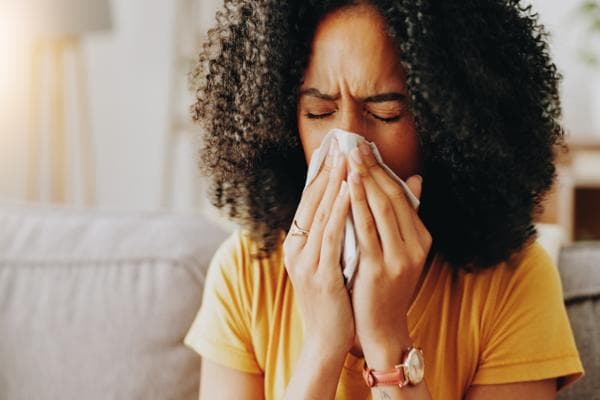 woman blowing nose
