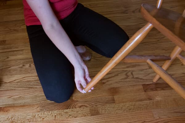 woman placing protector to bottom of chair