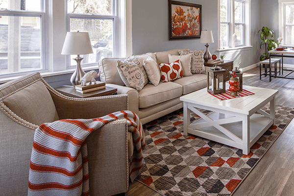 Love your home again Open living room with hardwood, a white couch and red accents