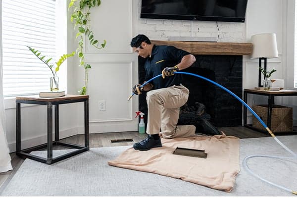 Technician cleaning air ducts