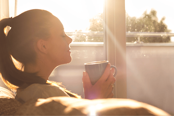 Woman breathing in cleaner indoor air