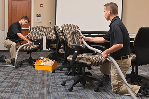 Technicians cleaning office chairs Technicians cleaning office chairs
