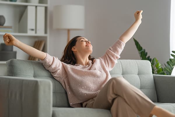 woman relaxing on gray couch
