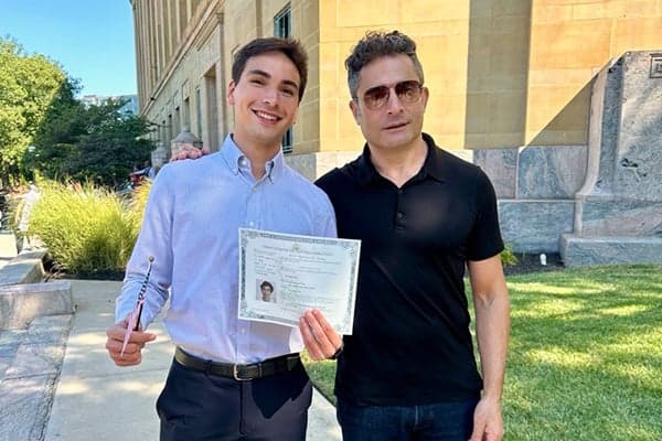Joel & Dad joel and dad with american flag outside state building