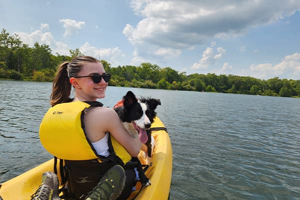 lilah on lake blog author and border collie in kayak on lake