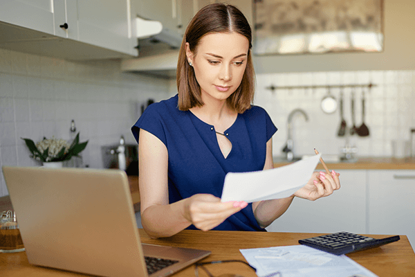 Woman looking over carpet cleaning offers and prices Woman looking over carpet cleaning offers and prices