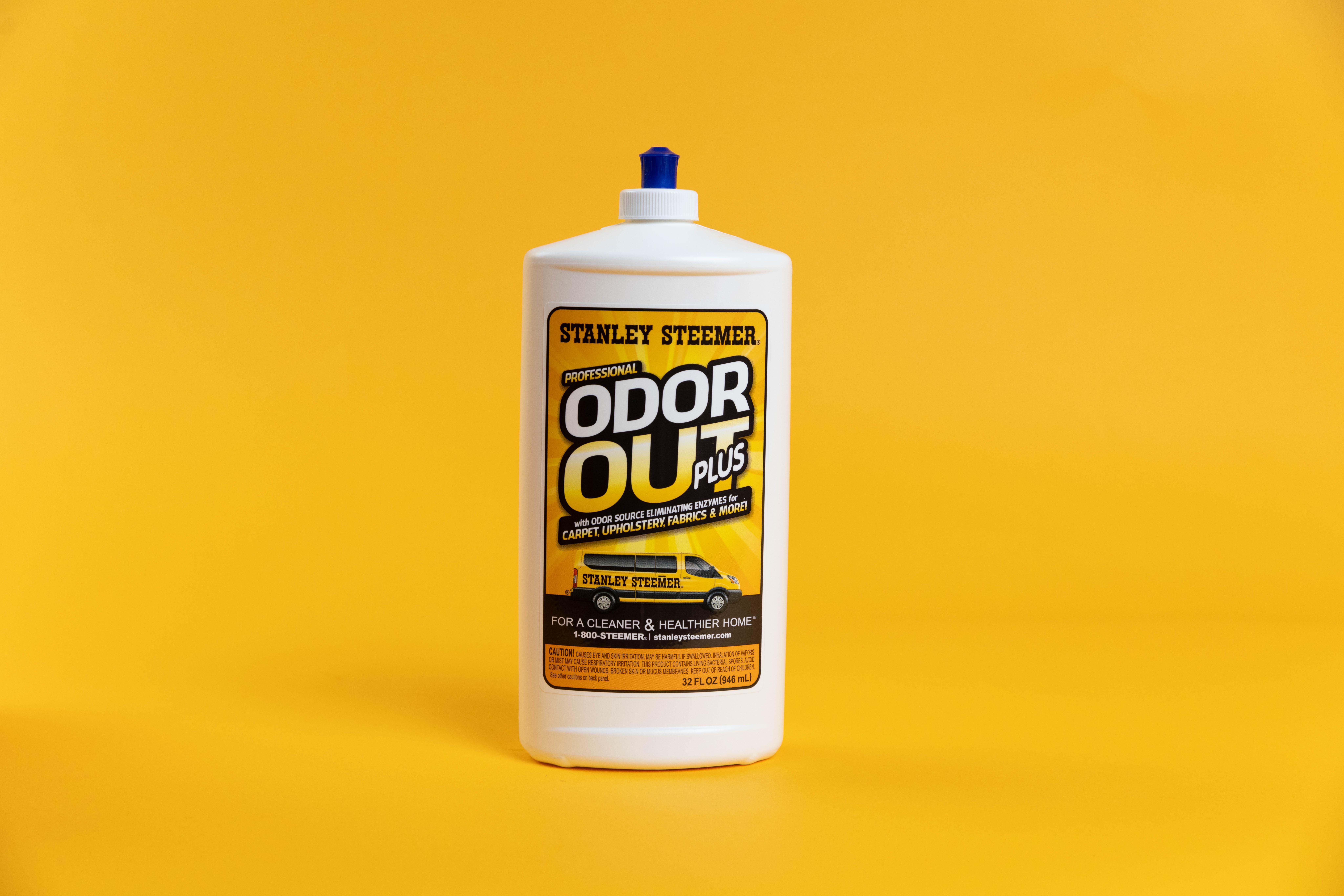 Stanley Steemer Odor Out Plus Stanley Steemer odor out plus bottle against orange background