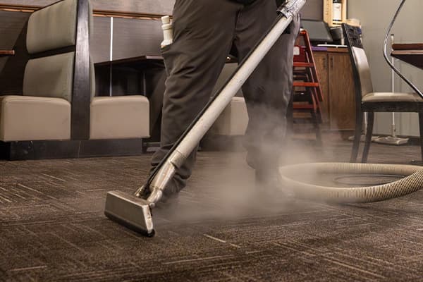 tech cleaning carpet at restaurant
