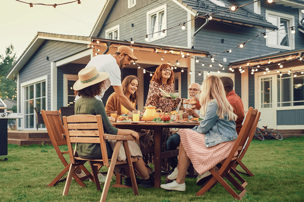family in backyard outside eating dinner