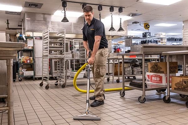 Stanley Steemer Technician Deep Cleaning Tile and Grout in a Restaurant Stanley Steemer technician deep cleaning tile and grout in a restaurant