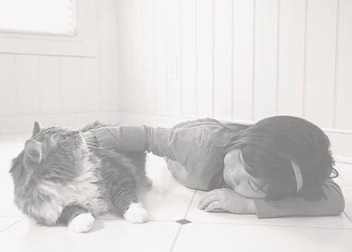 Tile-and-Grout-Cleaning-Girl-and-Cat-on-Clean-Tile Young girl laying on a clean tile floor with a cat.